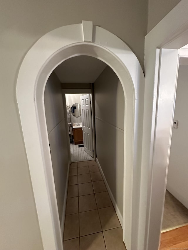 18 New St, Ansonia, CT 06401 - corridor with light tile patterned floors, arched walkways, washer / dryer, and baseboards