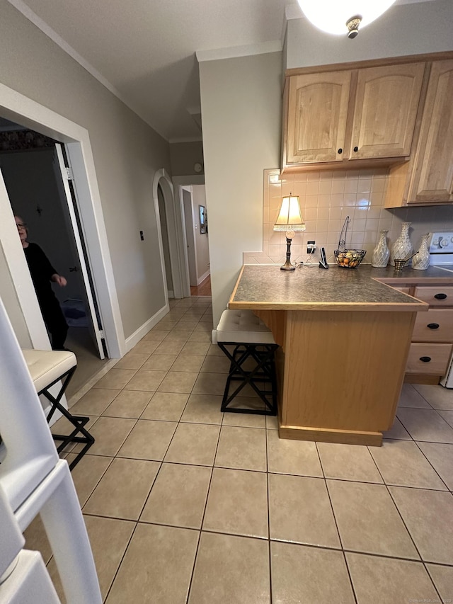 18 New St, Ansonia, CT 06401 - kitchen with light brown cabinetry, crown molding, tasteful backsplash, arched walkways, and light tile patterned flooring