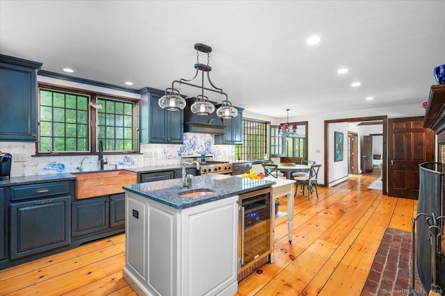 286 Limestone Rd, Ridgefield, CT 06877 - kitchen with beverage cooler, a sink, tasteful backsplash, dark stone countertops, and recessed lighting