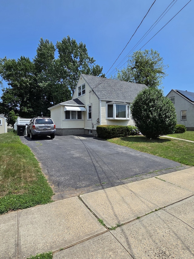 13 Harkness Dr, Milford, CT 06460 - view of front of home featuring asphalt driveway, a front lawn, and roof with shingles