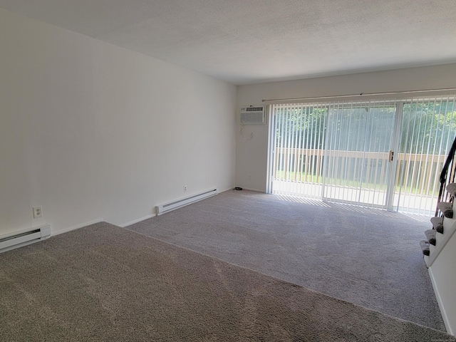 213 Baxter Rd Apt D, Mansfield, CT 06268 - spare room with a baseboard heating unit, carpet floors, a wall mounted air conditioner, and a textured ceiling