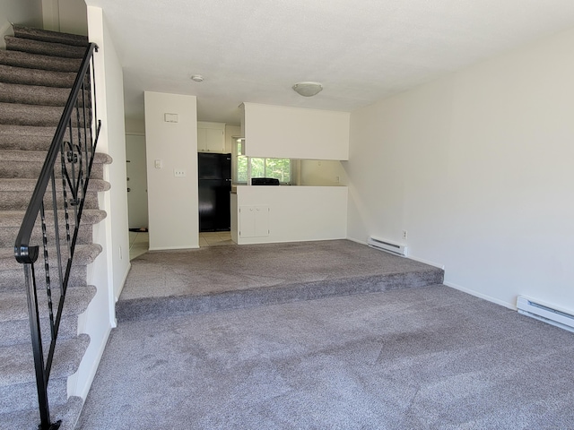 213 Baxter Rd Apt D, Mansfield, CT 06268 - unfurnished living room with a baseboard heating unit, stairway, light carpet, and baseboards