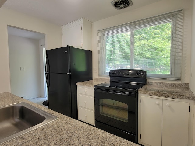 213 Baxter Rd Apt D, Mansfield, CT 06268 - kitchen featuring black appliances, tile counters, plenty of natural light, and white cabinets