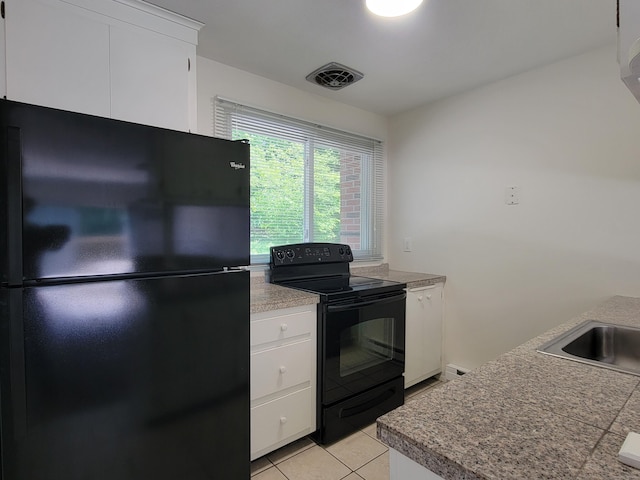 213 Baxter Rd Apt D, Mansfield, CT 06268 - kitchen with black appliances, light tile patterned floors, white cabinets, a sink, and a baseboard radiator