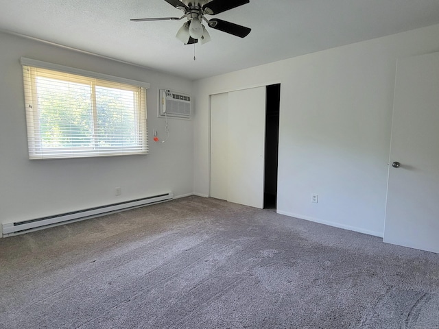 213 Baxter Rd Apt D, Mansfield, CT 06268 - unfurnished bedroom with a baseboard heating unit, carpet, a wall mounted AC, a closet, and ceiling fan