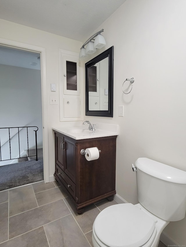 213 Baxter Rd Apt D, Mansfield, CT 06268 - bathroom featuring vanity, toilet, baseboards, and tile patterned floors
