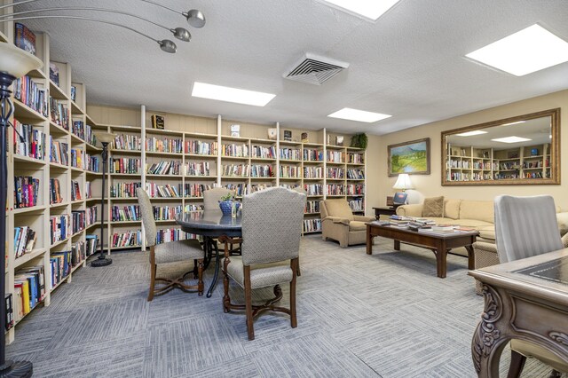 1 Strawberry Hill Ave Apt 7A, Stamford, CT 06902 - office space featuring wall of books, carpet flooring, and a textured ceiling