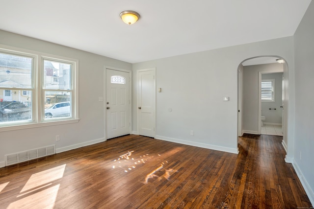 82 Sunnyside Ave, Waterbury, CT 06708 - foyer with arched walkways, dark wood-style flooring, and baseboards