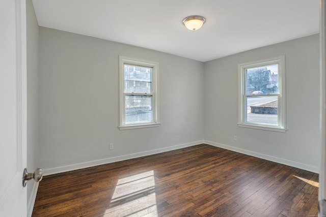 82 Sunnyside Ave, Waterbury, CT 06708 - unfurnished room with healthy amount of natural light, dark wood finished floors, and baseboards