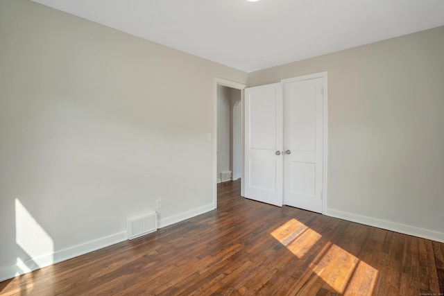 82 Sunnyside Ave, Waterbury, CT 06708 - unfurnished bedroom with baseboards, dark wood finished floors, and a closet