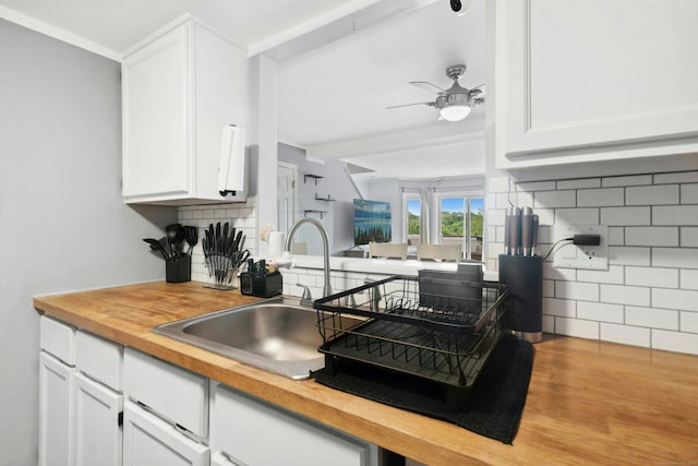 173 Russo Ave Unit 406, East Haven, CT 06513 - kitchen with wood counters, a sink, tasteful backsplash, a ceiling fan, and white cabinetry