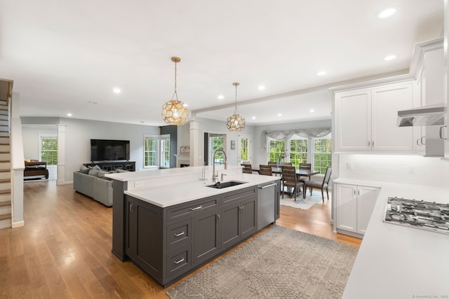 41 Leeward Ln, Groton, CT 06340 - kitchen featuring a sink, white cabinetry, light countertops, appliances with stainless steel finishes, and an island with sink