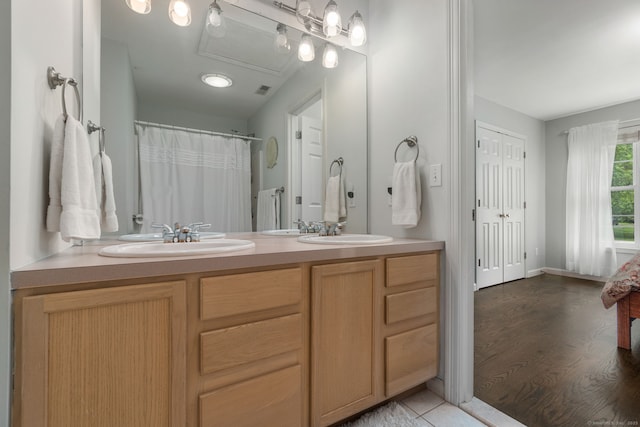 41 Leeward Ln, Groton, CT 06340 - full bathroom with double vanity, a shower with curtain, wood finished floors, and baseboards