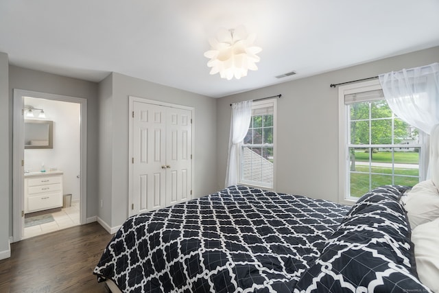 41 Leeward Ln, Groton, CT 06340 - bedroom featuring dark wood finished floors, baseboards, a closet, and connected bathroom