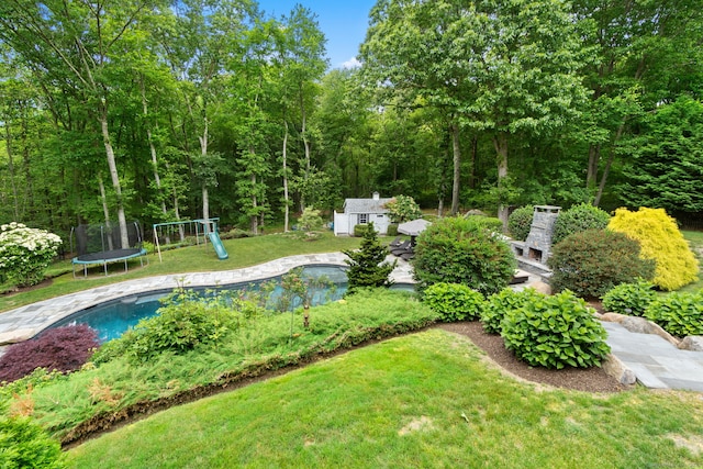 41 Leeward Ln, Groton, CT 06340 - view of green lawn featuring an outdoor structure, an outdoor pool, a playground, and a trampoline