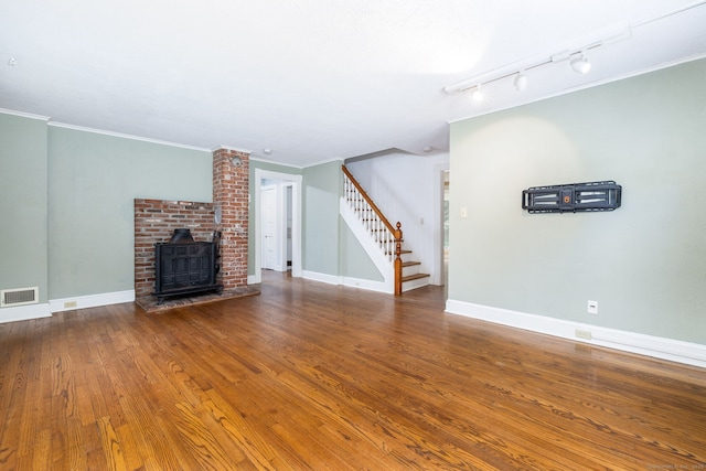 127 Matson Hill Rd, Glastonbury, CT 06073 - unfurnished living room featuring stairway, rail lighting, ornamental molding, wood finished floors, and baseboards