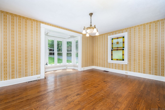 127 Matson Hill Rd, Glastonbury, CT 06073 - unfurnished room featuring a chandelier, wood finished floors, baseboards, and wallpapered walls