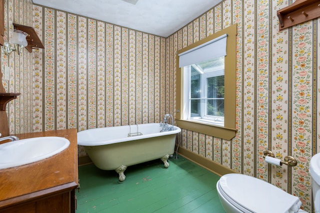 127 Matson Hill Rd, Glastonbury, CT 06073 - bathroom with a freestanding tub, wood finished floors, toilet, wallpapered walls, and vanity