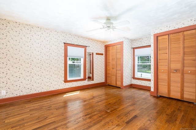 127 Matson Hill Rd, Glastonbury, CT 06073 - unfurnished bedroom featuring two closets, wood finished floors, wallpapered walls, baseboards, and ceiling fan