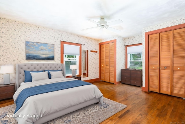 127 Matson Hill Rd, Glastonbury, CT 06073 - bedroom featuring multiple closets, wallpapered walls, multiple windows, wood finished floors, and ceiling fan