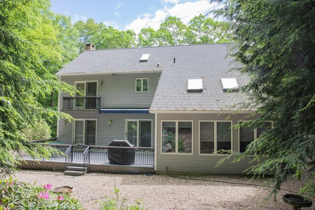 43 Metacomet Rd, Farmington, CT 06032 - back of property with a balcony, a chimney, a shingled roof, and a deck