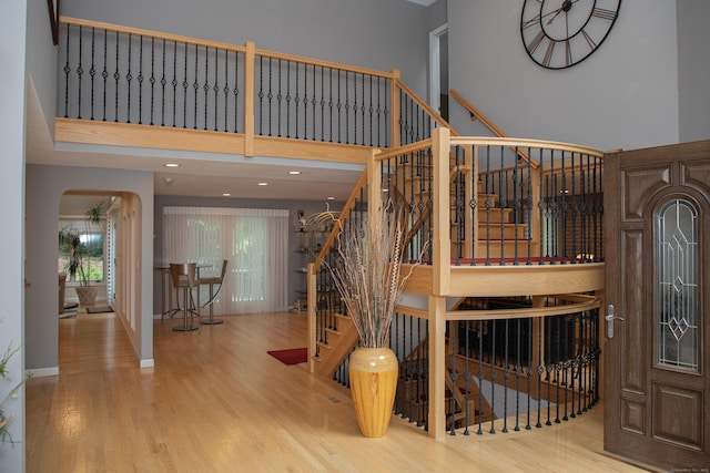 43 Metacomet Rd, Farmington, CT 06032 - stairway featuring wood finished floors, arched walkways, baseboards, and a high ceiling