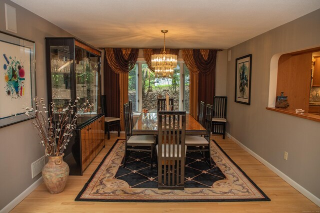 43 Metacomet Rd, Farmington, CT 06032 - dining area with a chandelier, light wood-type flooring, and baseboards