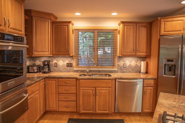 43 Metacomet Rd, Farmington, CT 06032 - kitchen with appliances with stainless steel finishes, a sink, a warming drawer, light stone countertops, and decorative backsplash