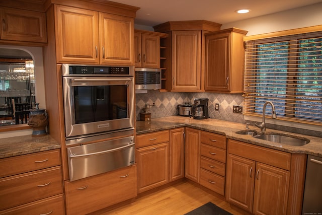 43 Metacomet Rd, Farmington, CT 06032 - kitchen with stainless steel appliances, a warming drawer, a sink, open shelves, and dark stone counters