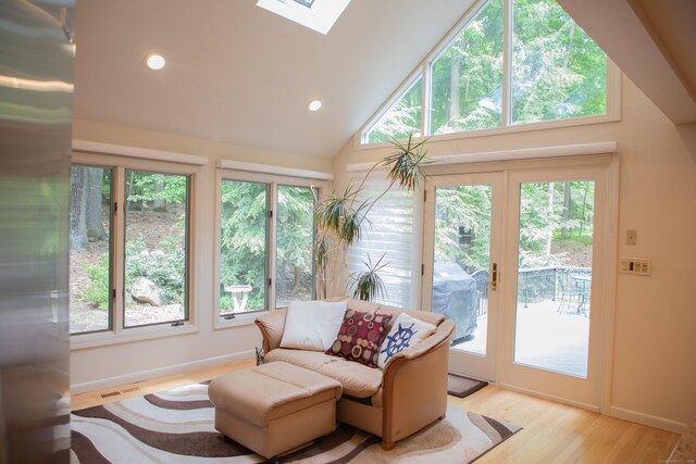 43 Metacomet Rd, Farmington, CT 06032 - living room featuring a skylight, plenty of natural light, light wood-type flooring, recessed lighting, and a high ceiling