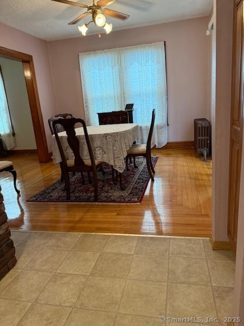 11 Deerfield St, East Haven, CT 06512 - dining room featuring ceiling fan, baseboards, light wood-style floors, and radiator