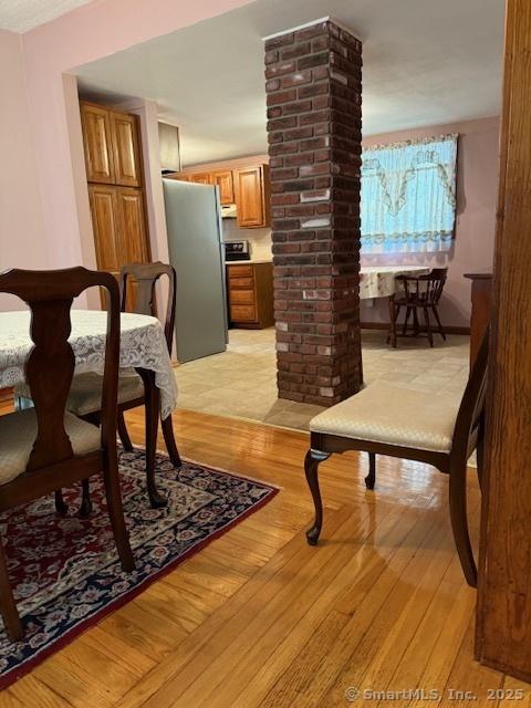 11 Deerfield St, East Haven, CT 06512 - dining space featuring decorative columns and light wood-style floors