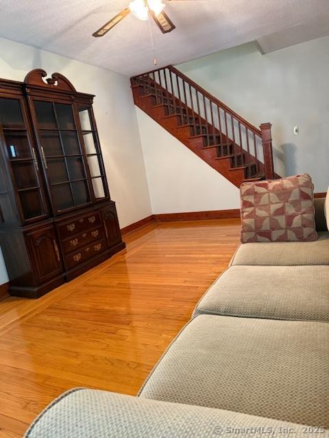 11 Deerfield St, East Haven, CT 06512 - living area with a ceiling fan, baseboards, stairway, and wood finished floors