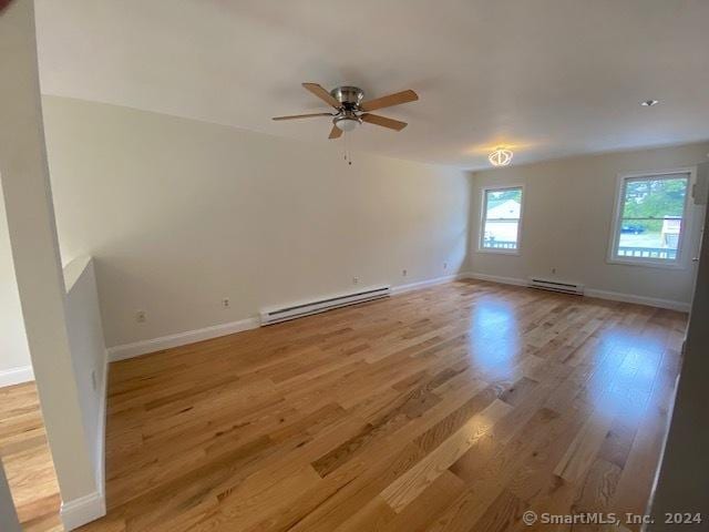 57 Senior Dr Unit 57, Monroe, CT 06468 - spare room featuring a baseboard radiator, ceiling fan, light wood-type flooring, and baseboards
