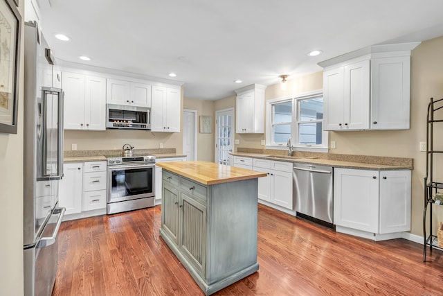 44 Josies Ring Rd, Monroe, CT 06468 - kitchen with stainless steel appliances, wooden counters, recessed lighting, wood finished floors, and white cabinetry