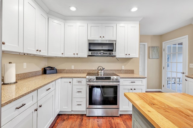 44 Josies Ring Rd, Monroe, CT 06468 - kitchen featuring appliances with stainless steel finishes, butcher block countertops, recessed lighting, white cabinets, and wood finished floors