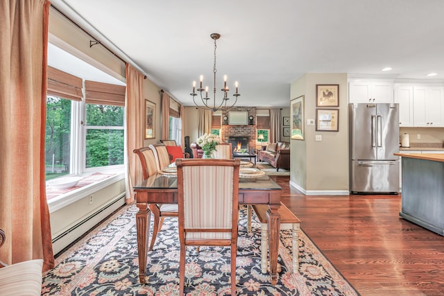 44 Josies Ring Rd, Monroe, CT 06468 - dining room with a baseboard heating unit, dark wood finished floors, a chandelier, a fireplace, and recessed lighting