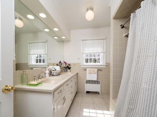 27 Powderhorn Dr, Ridgefield, CT 06877 - full bath featuring radiator, tile walls, double vanity, tile patterned flooring, and plenty of natural light