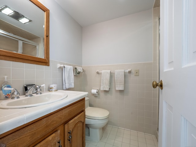 27 Powderhorn Dr, Ridgefield, CT 06877 - full bathroom featuring vanity, toilet, tile patterned flooring, tile walls, and a shower with door