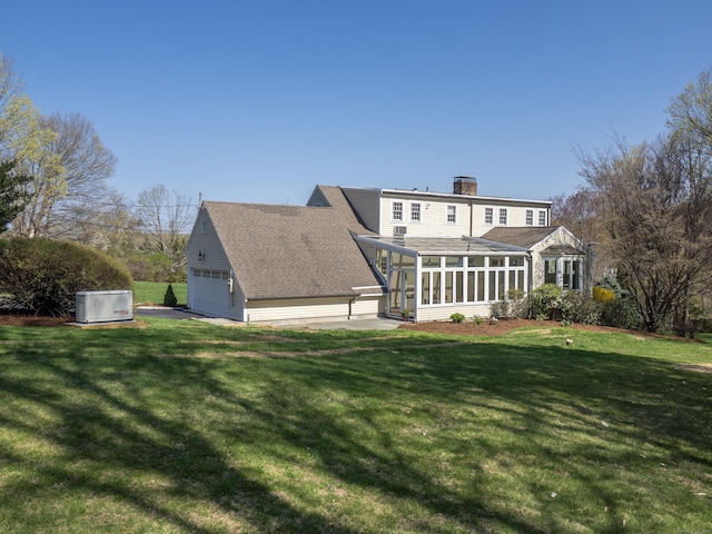 27 Powderhorn Dr, Ridgefield, CT 06877 - back of house with a sunroom, a chimney, and a lawn