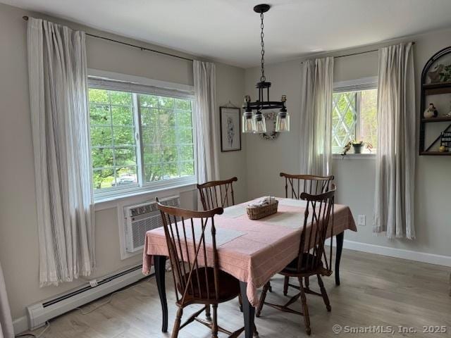 12 Derby Ct Unit 12, Brookfield, CT 06804 - dining room featuring a baseboard radiator, a chandelier, light wood-style floors, and baseboards
