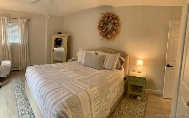 12 Derby Ct Unit 12, Brookfield, CT 06804 - bedroom with light wood finished floors and a baseboard heating unit