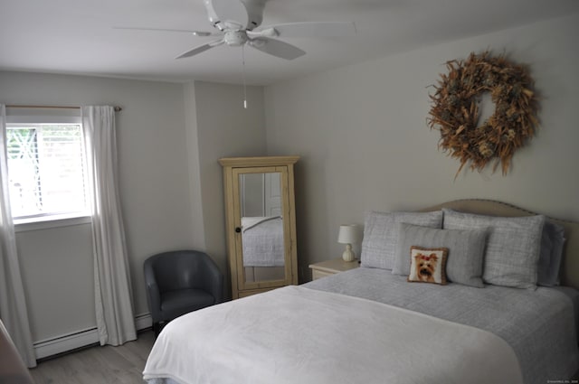 12 Derby Ct Unit 12, Brookfield, CT 06804 - bedroom featuring a baseboard heating unit, light wood-style floors, and a ceiling fan