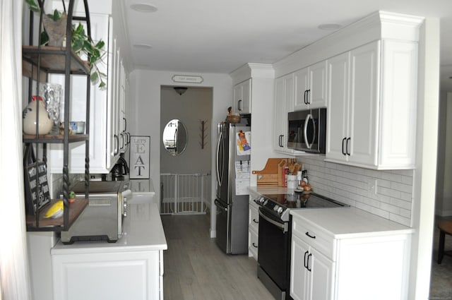 12 Derby Ct Unit 12, Brookfield, CT 06804 - kitchen with appliances with stainless steel finishes, backsplash, white cabinetry, and light wood-style flooring