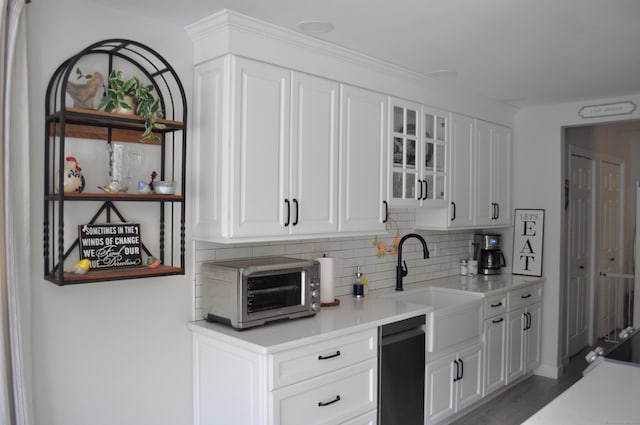 12 Derby Ct Unit 12, Brookfield, CT 06804 - kitchen featuring dishwasher, backsplash, a sink, light countertops, and glass insert cabinets
