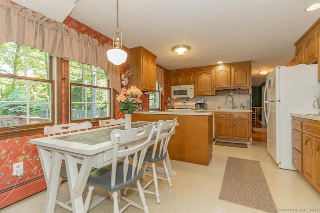 37 Sage Dr, Berlin, CT 06037 - kitchen with white appliances, brown cabinetry, light countertops, a sink, and recessed lighting