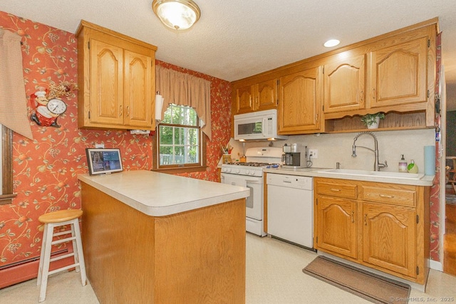 37 Sage Dr, Berlin, CT 06037 - kitchen with white appliances, wallpapered walls, a sink, a peninsula, and light countertops