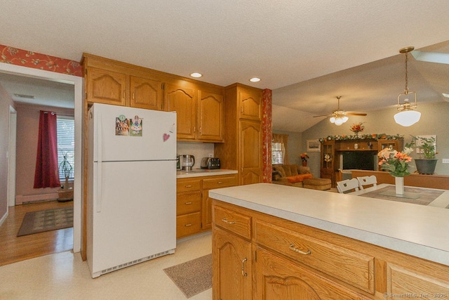 37 Sage Dr, Berlin, CT 06037 - kitchen with freestanding refrigerator, light countertops, brown cabinetry, hanging light fixtures, and ceiling fan