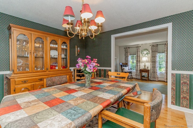 37 Sage Dr, Berlin, CT 06037 - dining area featuring wallpapered walls, a chandelier, wood finished floors, and a textured ceiling