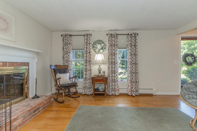 37 Sage Dr, Berlin, CT 06037 - living area featuring wood finished floors, a fireplace, a baseboard heating unit, and baseboards